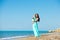 Happy family in a blue dress. Mother with baby on the beach