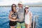 Happy family on boat during tropical beach vacation