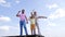 Happy family of boy child with dad and grandad point fingers holding paper planes sky-high, pointing