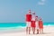 Happy family on the caribbean beach celebrating Christmas vacation