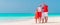 Happy family on the caribbean beach celebrating Christmas vacation