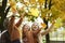 Happy family catching autumnal leafs