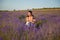 Happy family caucasian young mother and her child on summer lavender flower field during leisure holiday