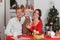 Happy family celebration of the New Year. The mother, father and little son sitting at the table.