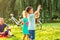 Happy Family-Cheerful children chase bubbles in nature