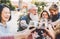 Happy family cheering and toasting with red wine glasses at dinner outdoor - People with different ages and ethnicity having fun