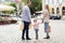 Happy family with child and shopping bags in city