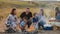 Happy family with children around the campfire on a picnic