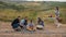 Happy family with children around the campfire on a picnic