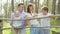 Happy family with children communicating and laughting in the forest sunny day