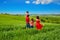 Happy family with children having fun outdoors on green field, spring family vacation with kids in Tuscany, Italy
