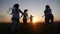 Happy family children kids together run in the park at sunset silhouette. people in the park concept mom dad daughter