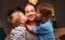 Happy family! Children kisses moms evening before bedtime