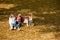 Happy family with children sitting on a grassy lawn