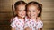 Happy family children twin sisters hugging