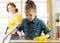 Happy family cleans room. Mother and her child daughter do cleaning in house. Woman and little kid girl wiped dust and vacuumed fl