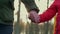 Happy family, composition. Hand adult man takes hand of young girl on background of beautiful beams of sunset. park