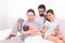 Happy family concept, father and daughter sit on bed excited looking new member in family, adorable newborn sleep on mother chest