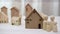 Happy family concept. Father going to work from home with wife and children together in front of house together. Miniature wooden