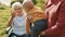 Happy family concept. Mother, grandmother in the wheelchair and baby having fun in nature