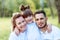 Happy family concept. Young mother and father with their daughter in the park