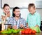 Happy family cooking veggy lunch