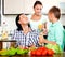 Happy family cooking veggy lunch