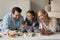 Happy family couple and daughter girl playing with toy blocks