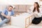 Happy Family Couple Installing Cabinet Shelf Together Furnishing New Home