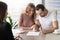 Happy family couple signing document, taking out bank loan, insu