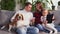 Happy family cuddling their dog beagle, having fun together in living room. Concept of pets, parenthood, love for