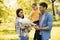 Happy family with cute bichon dog in the park