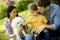 Happy family with cute bichon dog in the park