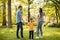 Happy family with cute bichon dog in the park