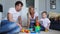 Happy family dad mom and baby 2 years playing lego in their bright living room. Slow-motion shooting happy family