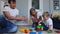 Happy family dad mom and baby 2 years playing lego in their bright living room. Slow-motion shooting happy family