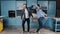 Happy family dance. Young couple fun dancing while cooking in the kitchen at home. Making dance moves