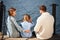 Happy family with daughter fishing in pond in fall