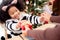 Happy family with daughter giving gift box with mother during dinner at home, celebration in xmas with children surprising parent.