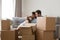 Happy family with daughter relax on couch on moving day