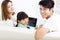 Happy family and daughter watching tablet on sofa