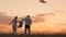 Happy family day, father mother and little kid fly a kite into the sky at sunset, play with child in nature in the