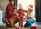 Happy family decorate Christmas tree, parents play with child son with garlands