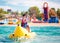 Happy family, delighted father and son having fun, riding on banana boat during summer vacation