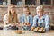 Happy family demonstrating freshly baked home pastry