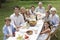 Happy Family Dining Together In Garden