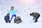 Happy family with dog outdoors in a snowy forest. Mother, fother, son and big pet dog.