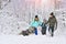 Happy family with dog outdoors in a winter forest. Mother, fother, son and big pet dog.