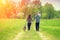 Happy family with dog walking on the rural dirt road