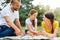 Happy family doing puzzle on picnic